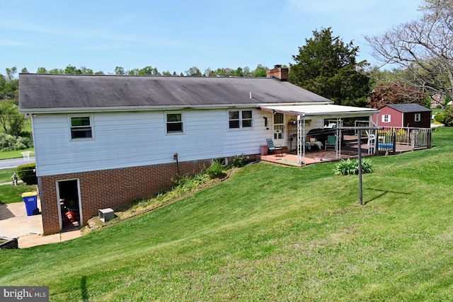 4092 Manchester St, Glen Rock, PA 17327 - rear view of property featuring a chimney, a lawn, brick siding, and a wooden deck