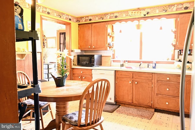 4092 Manchester St, Glen Rock, PA 17327 - kitchen featuring white dishwasher, black microwave, light floors, light countertops, and brown cabinets