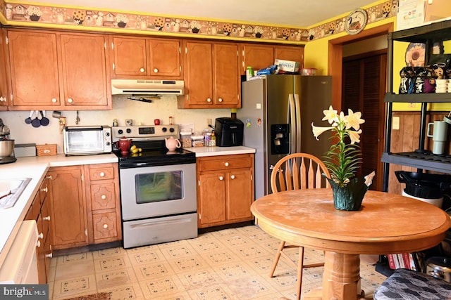 4092 Manchester St, Glen Rock, PA 17327 - kitchen with under cabinet range hood, appliances with stainless steel finishes, light countertops, and brown cabinets