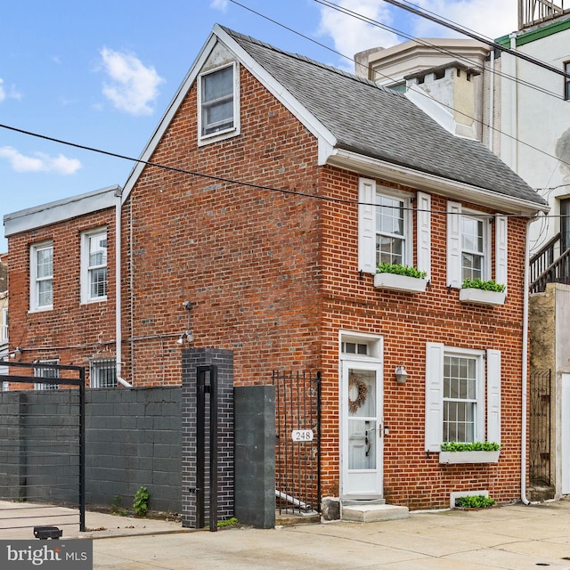 248 Greenwich St, Philadelphia, PA 19147 - view of front of home featuring brick siding, a shingled roof, and fence