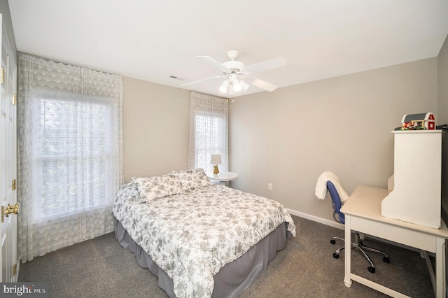 bedroom featuring dark colored carpet, baseboards, and ceiling fan