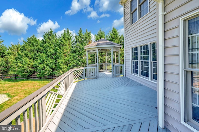 deck featuring a gazebo and a lawn