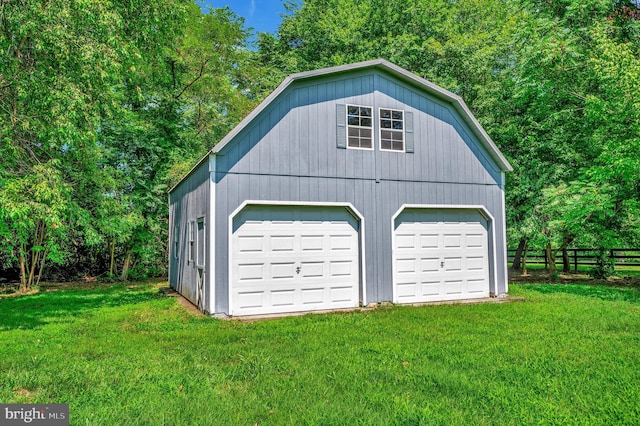 garage with fence and a detached garage