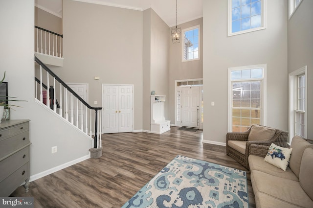 living room featuring wood finished floors, a high ceiling, and stairway
