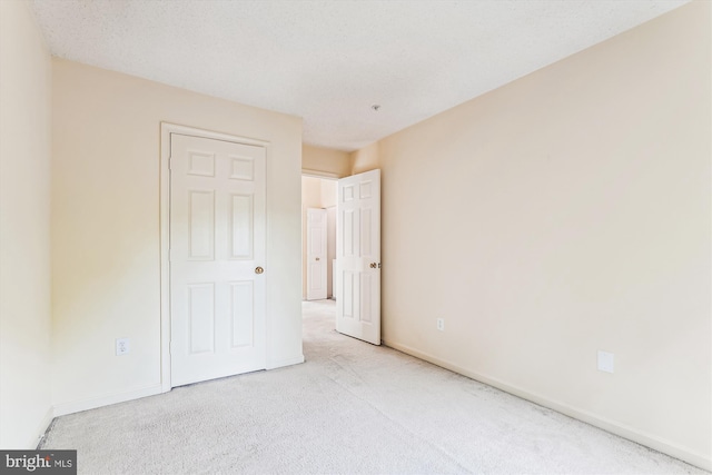 unfurnished bedroom with carpet and baseboards