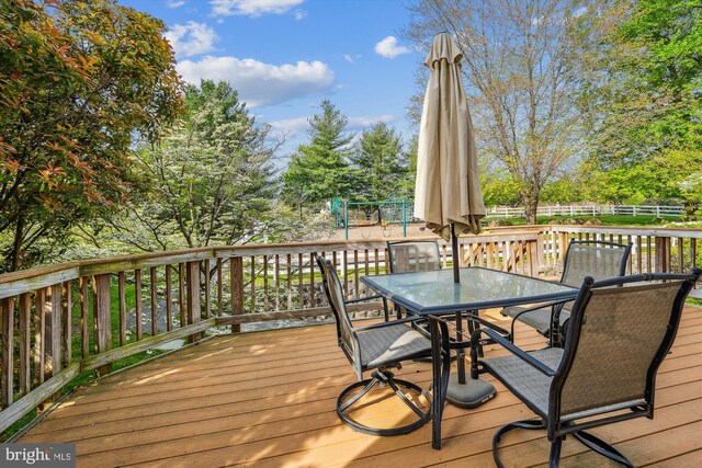 wooden terrace with fence and outdoor dining space
