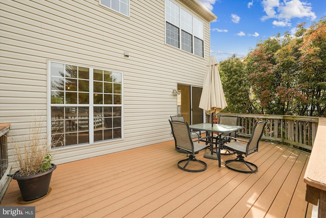wooden terrace featuring outdoor dining space