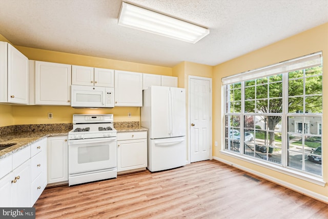 kitchen featuring white cabinetry, white appliances, light wood finished floors, and light stone counters
