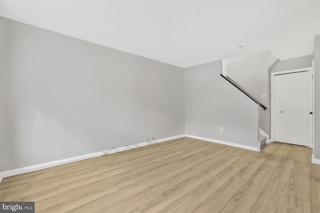 159 Heathfield Dr, Frederick, MD 21702 - unfurnished living room featuring light wood-type flooring, baseboards, and stairway