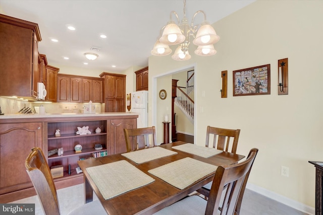 dining space with a chandelier, recessed lighting, baseboards, visible vents, and stairway