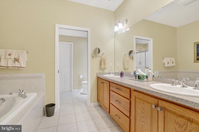full bath with a bath, double vanity, a sink, and tile patterned flooring