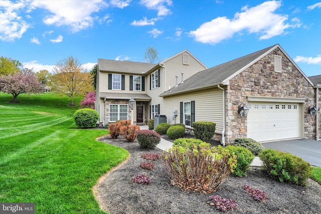 traditional-style house with an attached garage, stone siding, a front yard, central AC unit, and driveway