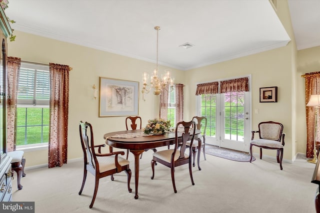 dining room with visible vents, crown molding, light colored carpet, baseboards, and an inviting chandelier