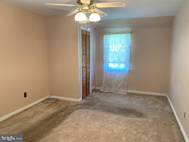 unfurnished room with ceiling fan, carpet floors, and baseboards