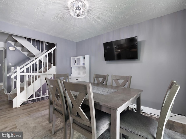331 Possum Ct, Capitol Heights, MD 20743 - dining room featuring stairway, a textured ceiling, baseboards, and wood finished floors