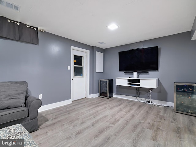 331 Possum Ct, Capitol Heights, MD 20743 - living room featuring beverage cooler, baseboards, wood finished floors, and visible vents