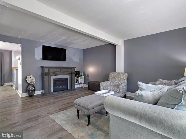 331 Possum Ct, Capitol Heights, MD 20743 - living room with a glass covered fireplace, baseboards, beamed ceiling, and wood finished floors