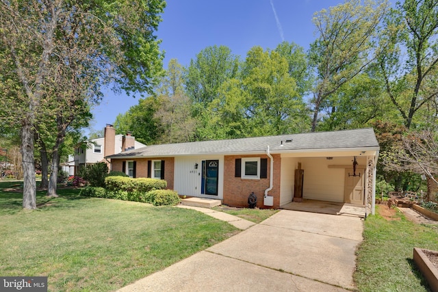 view of front of property with concrete driveway, a front lawn, a chimney, an attached carport, and brick siding