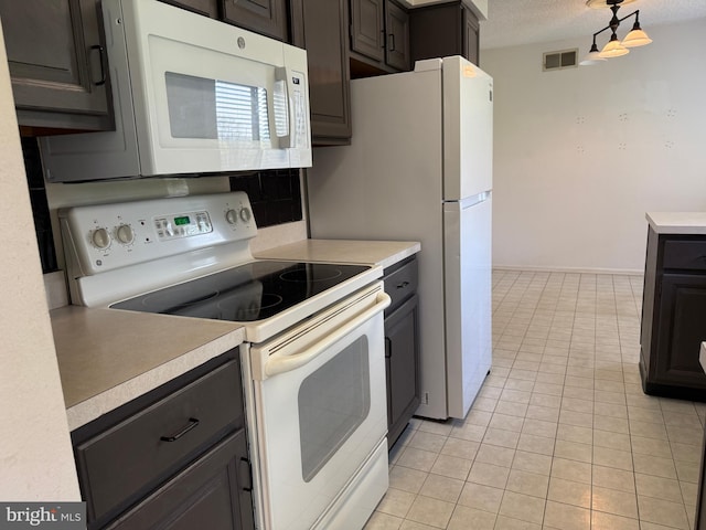 492 Delair Rd Unit C, Monroe, NJ 08831 - kitchen featuring a textured ceiling, light tile patterned flooring, white appliances, light countertops, and visible vents