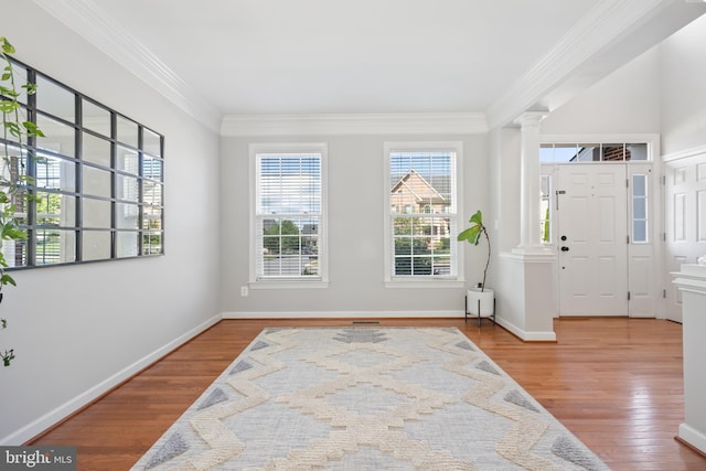 14401 Broadwinged Dr, Gainesville, VA 20155 - entrance foyer with decorative columns, healthy amount of natural light, wood finished floors, crown molding, and baseboards