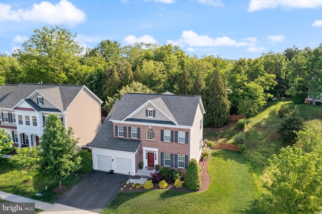14401 Broadwinged Dr, Gainesville, VA 20155 - view of front of house with asphalt driveway, a front lawn, a shingled roof, and an attached garage