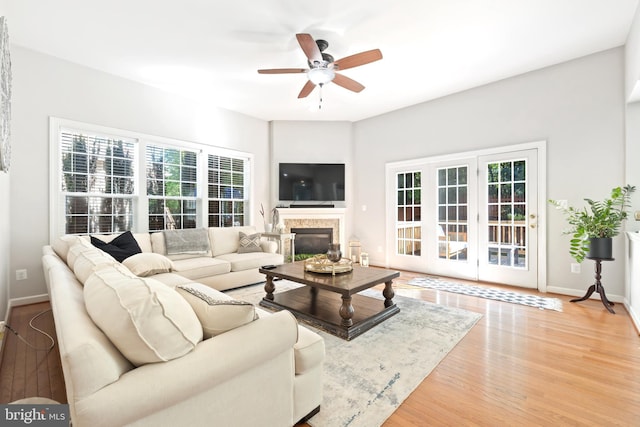 14401 Broadwinged Dr, Gainesville, VA 20155 - living area featuring ceiling fan, wood finished floors, baseboards, and a glass covered fireplace