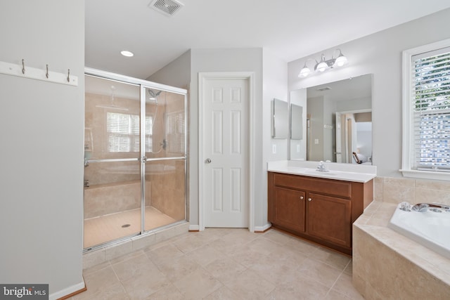 14401 Broadwinged Dr, Gainesville, VA 20155 - full bathroom with a shower stall, a garden tub, tile patterned floors, vanity, and recessed lighting