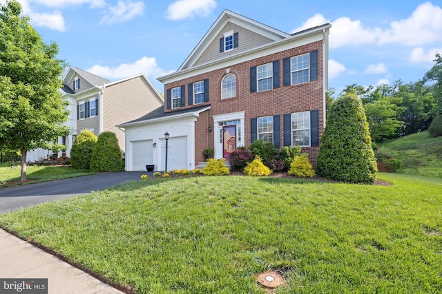 14401 Broadwinged Dr, Gainesville, VA 20155 - view of front facade with brick siding, driveway, a front yard, and a garage