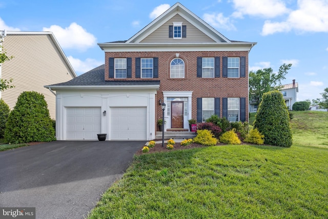 14401 Broadwinged Dr, Gainesville, VA 20155 - view of front of house with asphalt driveway, a front lawn, brick siding, and roof with shingles