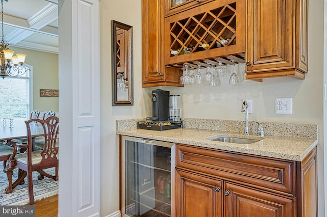 bar with crown molding, a sink, indoor wet bar, coffered ceiling, and wine cooler
