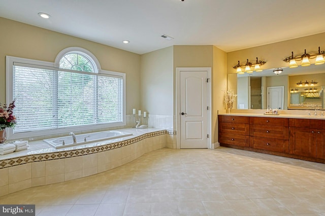 bathroom featuring a bath, tile patterned floors, visible vents, and vanity