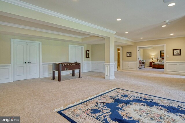 interior space featuring a decorative wall, crown molding, carpet flooring, and recessed lighting