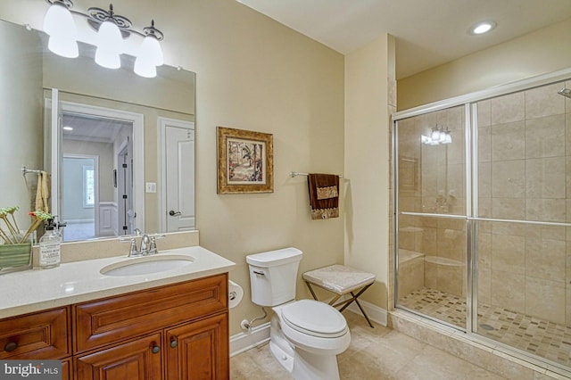 full bathroom with vanity, toilet, a stall shower, and tile patterned floors