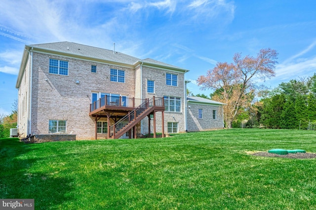 back of property featuring central AC unit, brick siding, stairs, a deck, and a yard