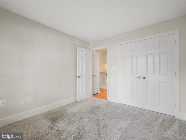 21019 Timber Ridge Ter Unit 102, Ashburn, VA 20147 - unfurnished bedroom with carpet floors, baseboards, and a closet