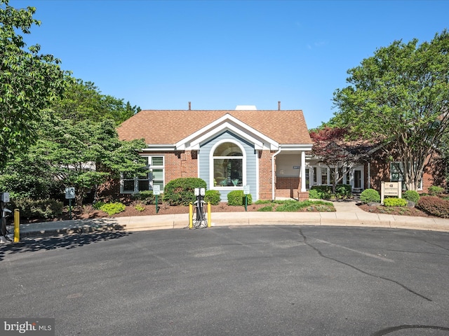 21019 Timber Ridge Ter Unit 102, Ashburn, VA 20147 - view of front of house featuring brick siding and a shingled roof