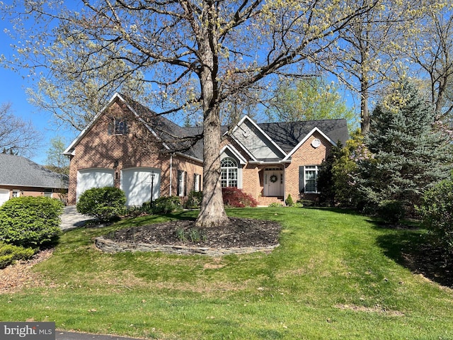 view of front of property featuring a front lawn, brick siding, and an attached garage