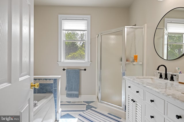 9050 Point Ln, Chestertown, MD 21620 - full bathroom with vanity, a healthy amount of sunlight, and a shower stall