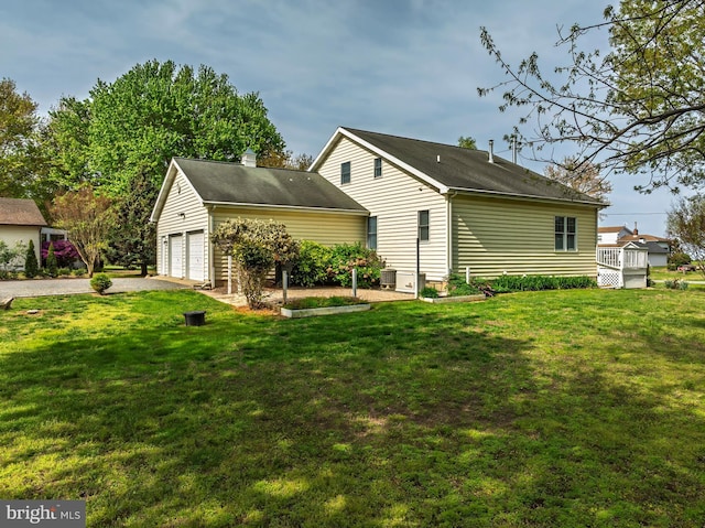 9050 Point Ln, Chestertown, MD 21620 - rear view of house with a lawn, a garage, and a chimney