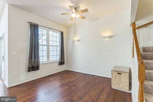 46878 Graham Cv, Sterling, VA 20165 - spare room with stairs, dark wood-style flooring, baseboards, and ceiling fan