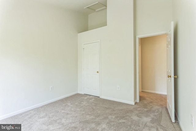 46878 Graham Cv, Sterling, VA 20165 - unfurnished bedroom with a towering ceiling, carpet, baseboards, and attic access