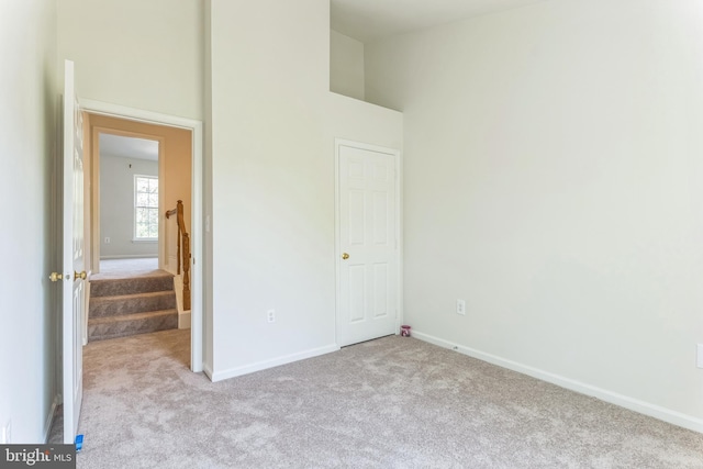 46878 Graham Cv, Sterling, VA 20165 - unfurnished bedroom with baseboards, a high ceiling, and carpet