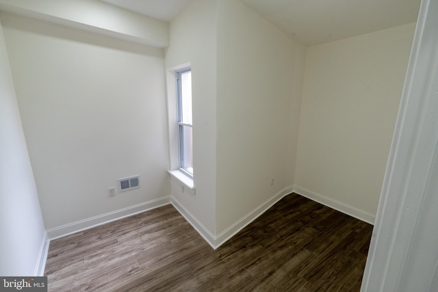 unfurnished room featuring wood finished floors and baseboards