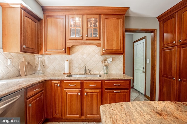 16 Hunters Ln, Chadds Ford, PA 19317 - kitchen featuring tasteful backsplash, stainless steel dishwasher, light stone countertops, light tile patterned floors, and a sink