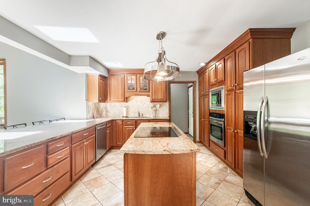 16 Hunters Ln, Chadds Ford, PA 19317 - kitchen with a kitchen island, light stone countertops, backsplash, a skylight, and stainless steel appliances