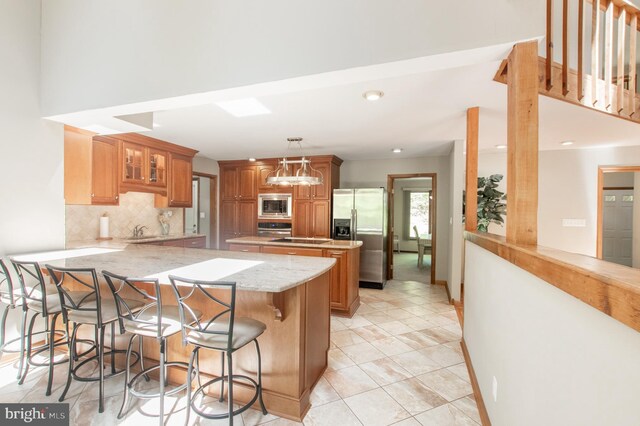16 Hunters Ln, Chadds Ford, PA 19317 - kitchen with a peninsula, glass insert cabinets, a sink, appliances with stainless steel finishes, and backsplash