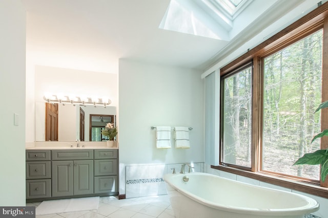 16 Hunters Ln, Chadds Ford, PA 19317 - bathroom featuring a skylight, vanity, tile patterned flooring, and a soaking tub