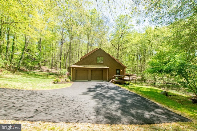 16 Hunters Ln, Chadds Ford, PA 19317 - exterior space featuring a detached garage, a wooden deck, and a front yard