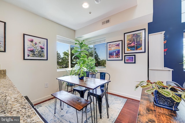 dining room with baseboards, dark wood-type flooring, and recessed lighting