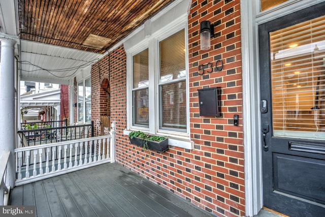 wooden terrace featuring covered porch